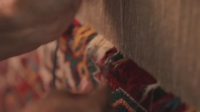 a women weaving an persian rugs